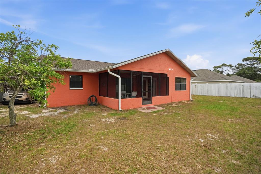 11286 Roland Street Spring Hill, FL 34609 - Photo 43 of 54 a front view of a house with a garden and yard