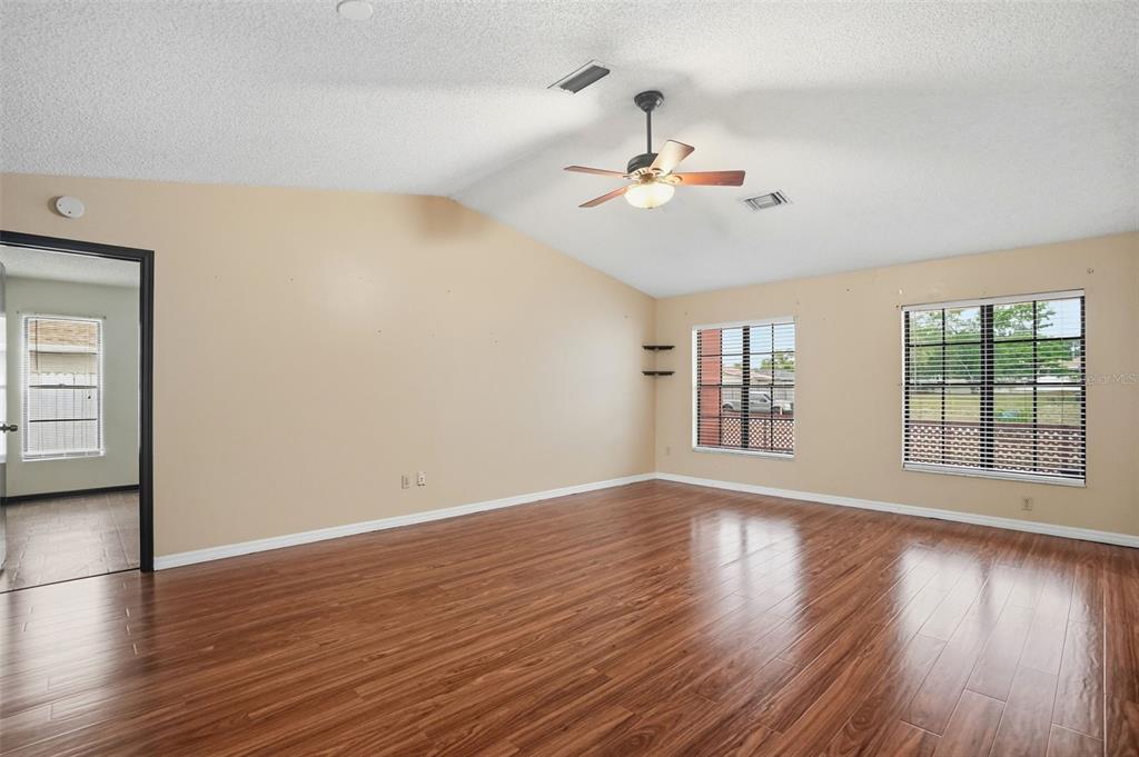 11286 Roland Street Spring Hill, FL 34609 - Photo 6 of 54 a view of an empty room with wooden floor and a window