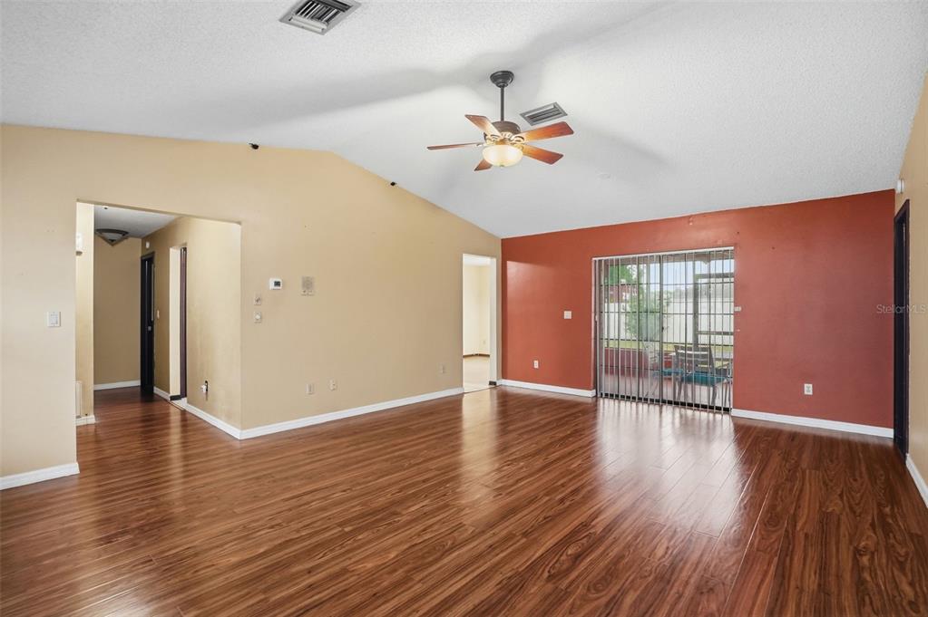 11286 Roland Street Spring Hill, FL 34609 - Photo 7 of 54 a view of an empty room with wooden floor and fan