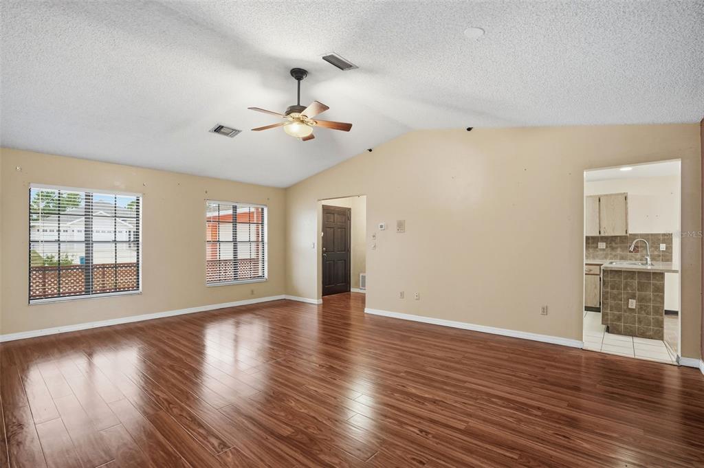 11286 Roland Street Spring Hill, FL 34609 - Photo 8 of 54 a view of an empty room with a window and wooden floor