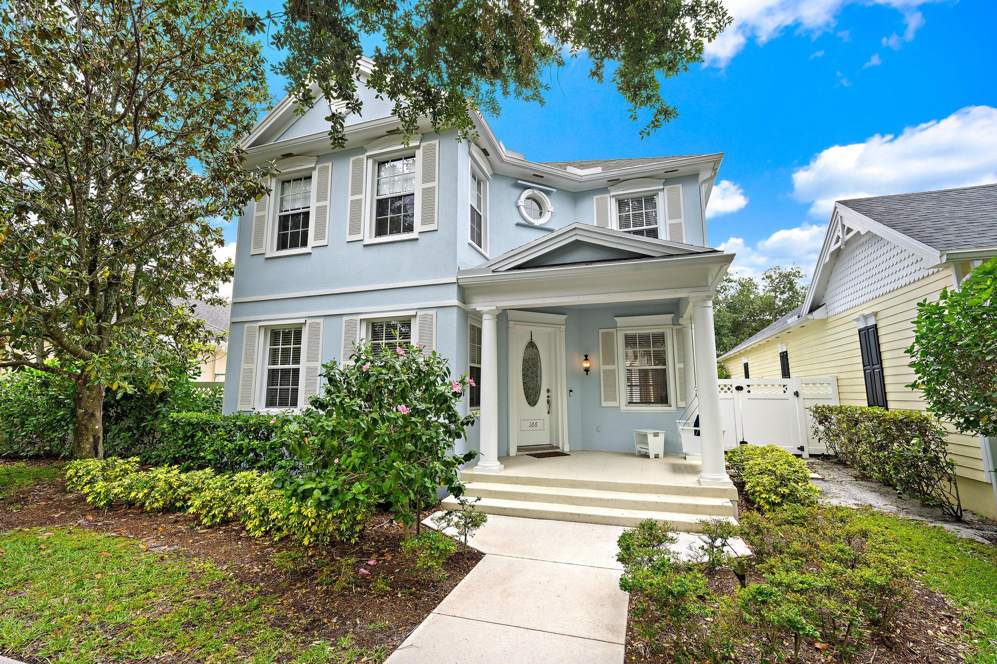 166 Honeysuckle Drive Jupiter, FL 33458 - Photo 1 of 26 a front view of a house with a garden