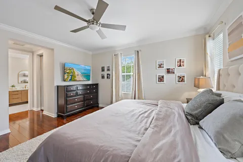 a bedroom with a bed dresser and a flat tv screen
