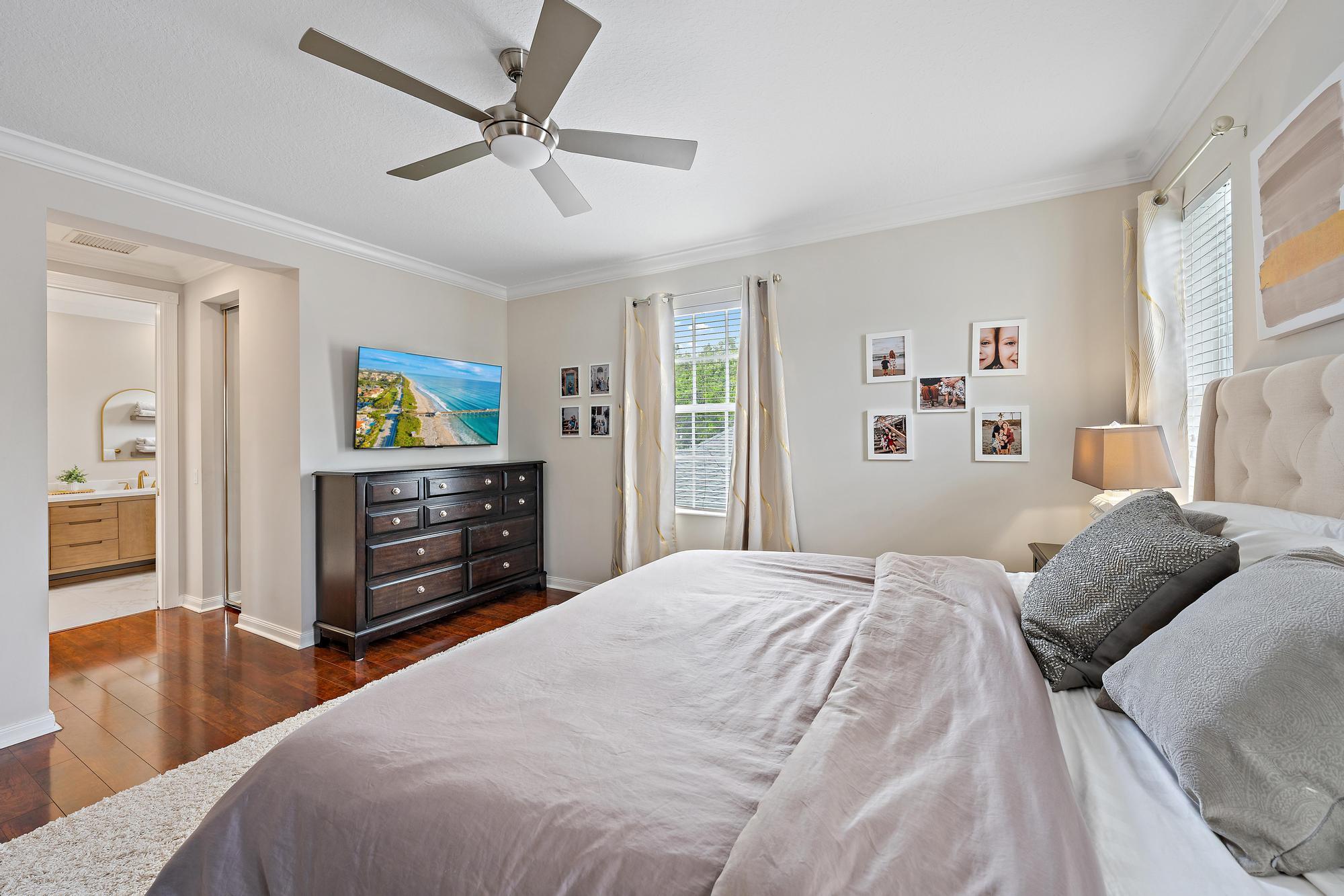 166 Honeysuckle Drive Jupiter, FL 33458 - Photo 13 of 26 a bedroom with a bed dresser and a flat tv screen