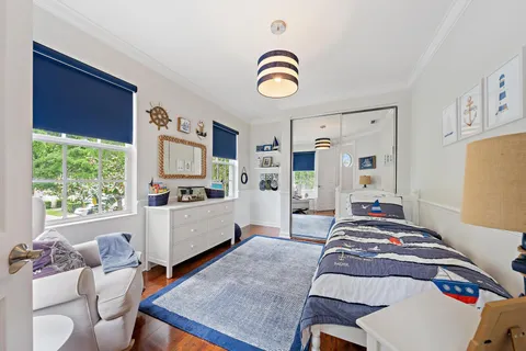 a bedroom with furniture and a window