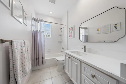 a bathroom with a double vanity sink toilet and shower