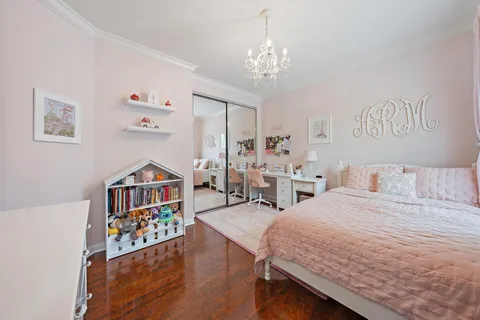 a bedroom with furniture and a chandelier