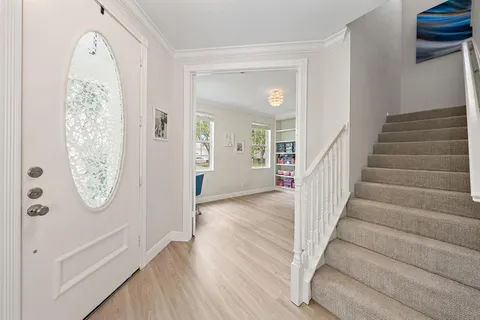 a view of an entryway with wooden floor