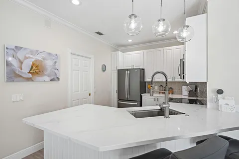 a kitchen with kitchen island a sink and a counter top space