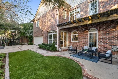 a front view of a house with a garden and patio