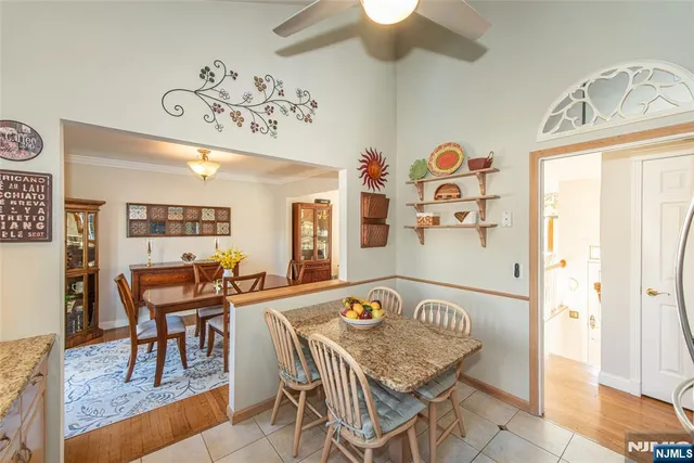 a view of a dining room with furniture and a chandelier
