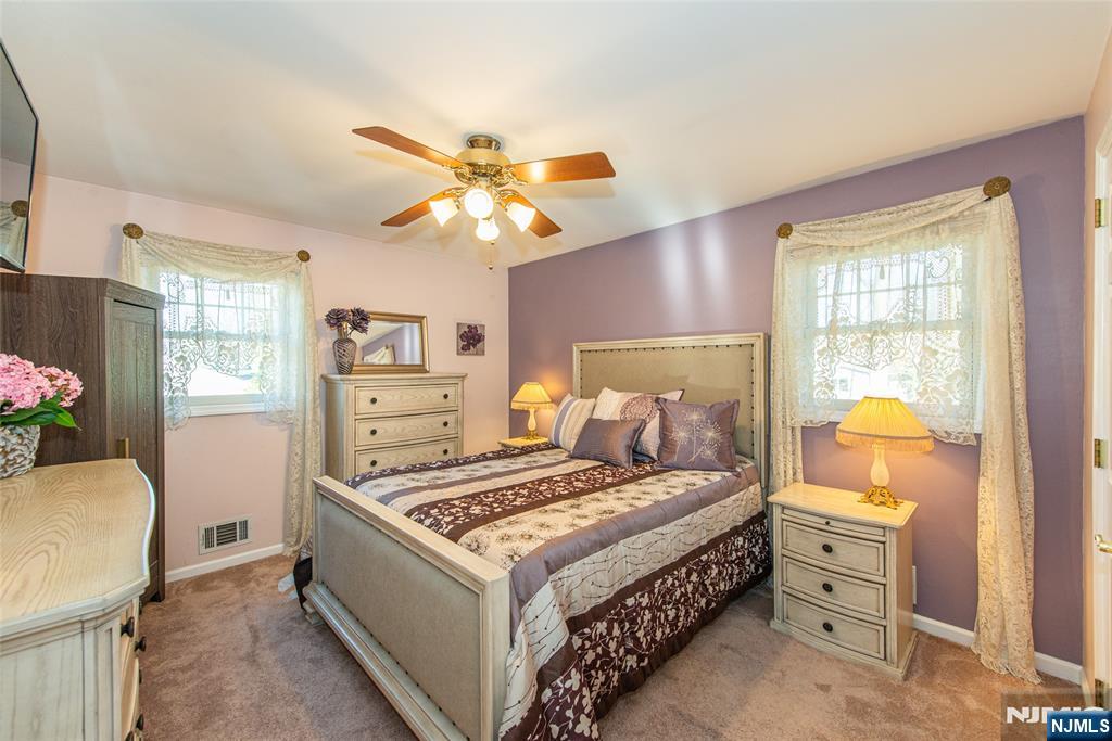 3 Springdale Road West Caldwell, NJ 07006 - Photo 19 of 38 a bedroom with a bed and a chandelier