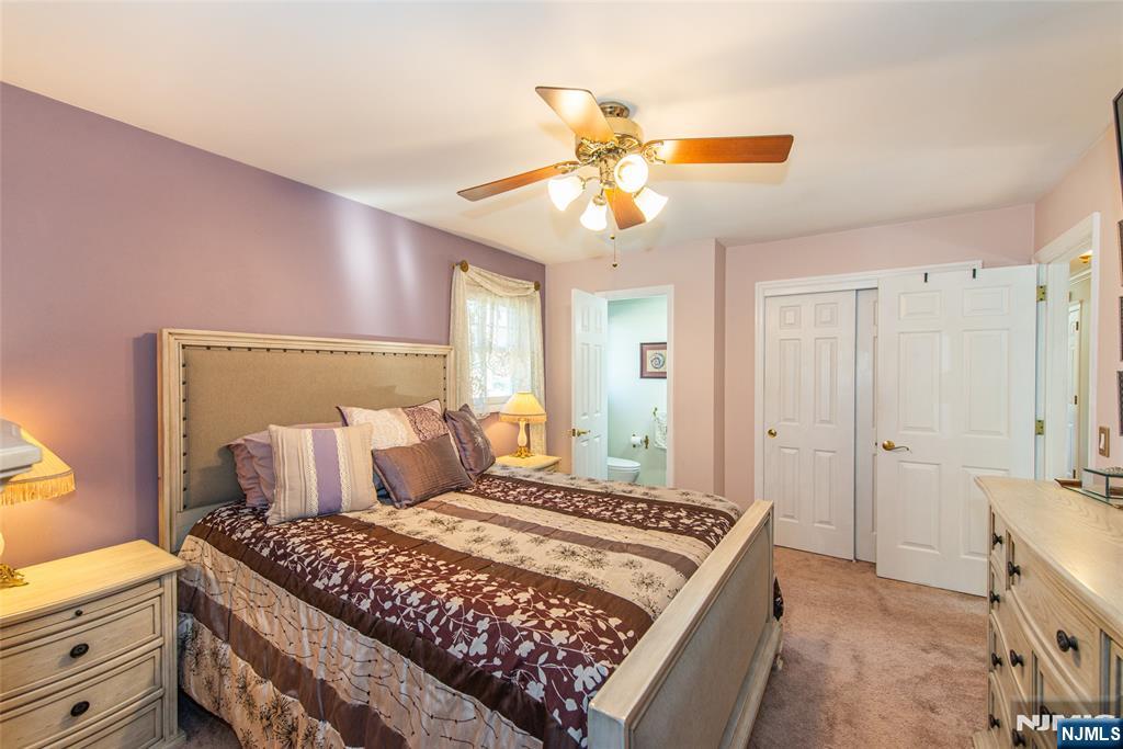 3 Springdale Road West Caldwell, NJ 07006 - Photo 20 of 38 a bedroom with a bed and a chandelier