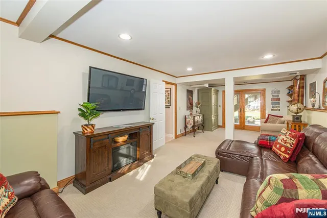 a living room with furniture flat screen tv and a fireplace