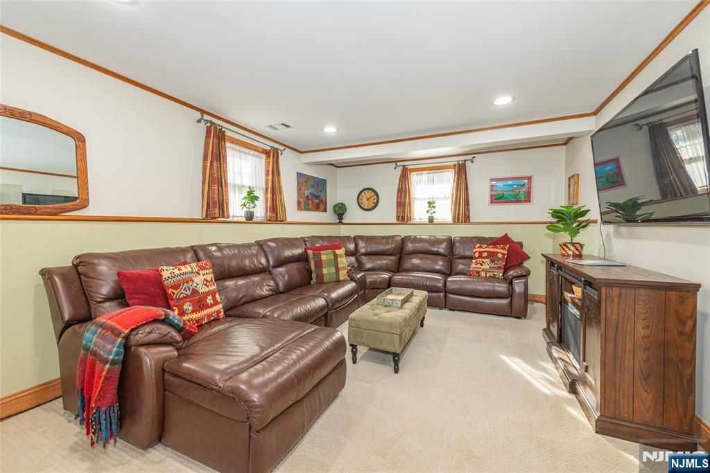 3 Springdale Road West Caldwell, NJ 07006 - Photo 28 of 38 a living room with furniture and a flat screen tv