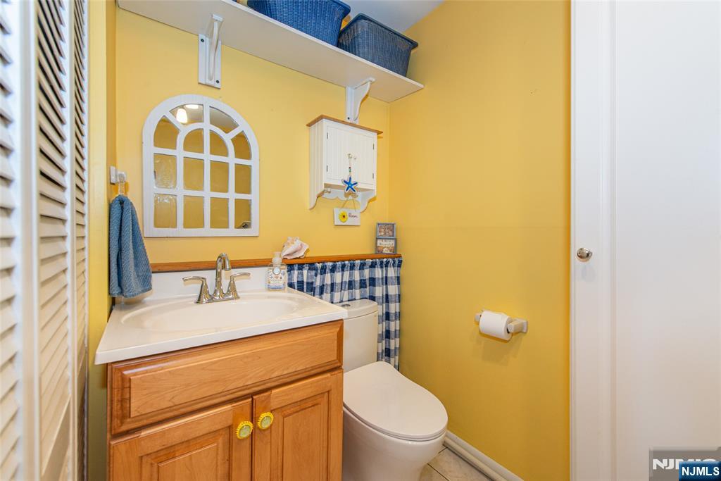 3 Springdale Road West Caldwell, NJ 07006 - Photo 30 of 38 a bathroom with a sink a toilet and a mirror