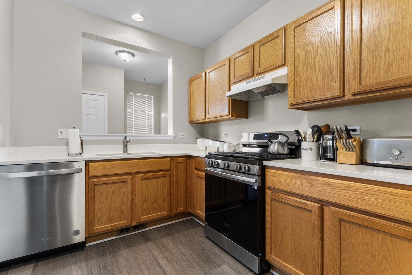 3133 Falling Waters Lane Lindenhurst, IL 60046 - Photo 2 of 15 a kitchen with stainless steel appliances granite countertop a sink stove and cabinets