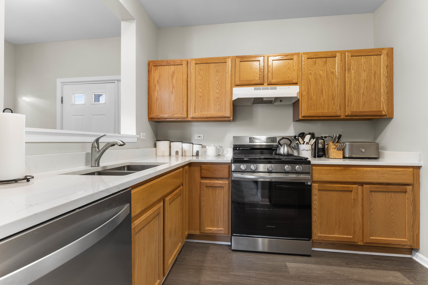 3133 Falling Waters Lane Lindenhurst, IL 60046 - Photo 3 of 15 a kitchen with stainless steel appliances granite countertop a sink stove and cabinets