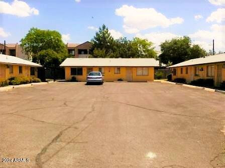 1445 South Kenneth Place, Unit H Tempe, AZ 85281 - Photo 1 of 7 a view of house with yard and trees in the background