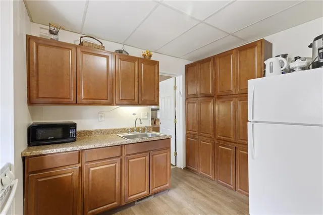 a kitchen with stainless steel appliances granite countertop a refrigerator and a sink