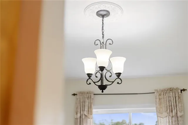 a close view of a light fixtures and window in a room