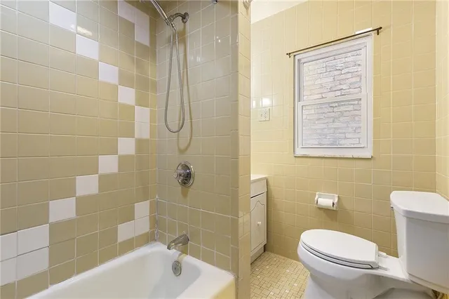 a bathroom with a toilet and shower
