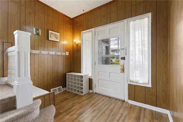 a view of an entryway with wooden floor and door