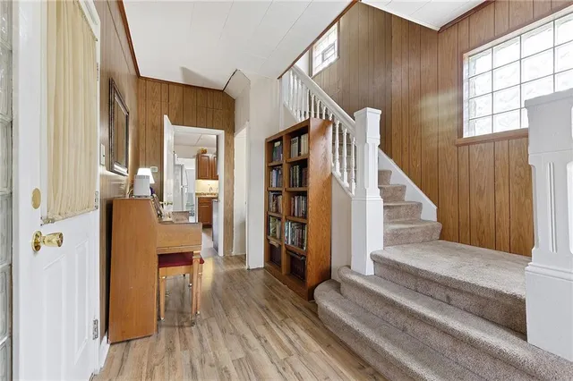 a view of entryway and hall with wooden floor