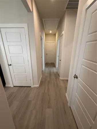 a view of a room with wooden floor