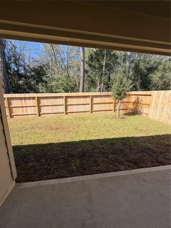 a view of an empty room with brick walls and windows