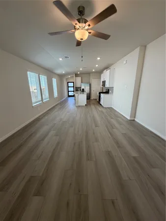 a white kitchen with kitchen island sink and white cabinets