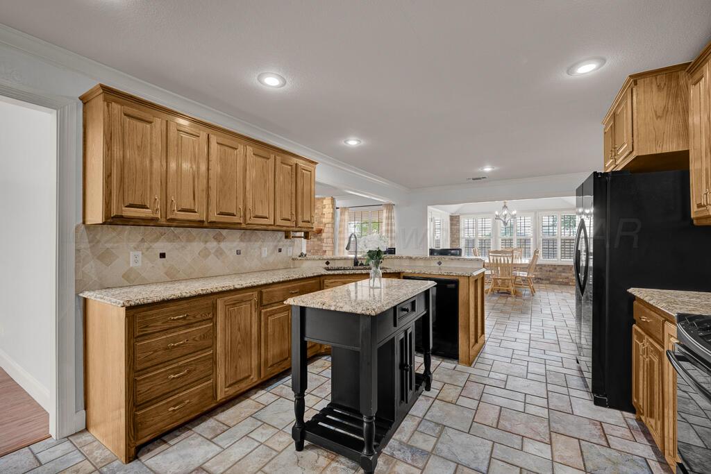 19933 Indian Spring Trail Bushland, TX 79124 - Photo 13 of 32 a kitchen with kitchen island granite countertop a sink counter top space appliances and cabinets