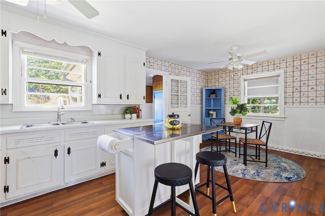 3400 Warner Road Richmond, VA 23225 - Photo 11 of 33 LVP flooring, white cabinetry, center island, eat