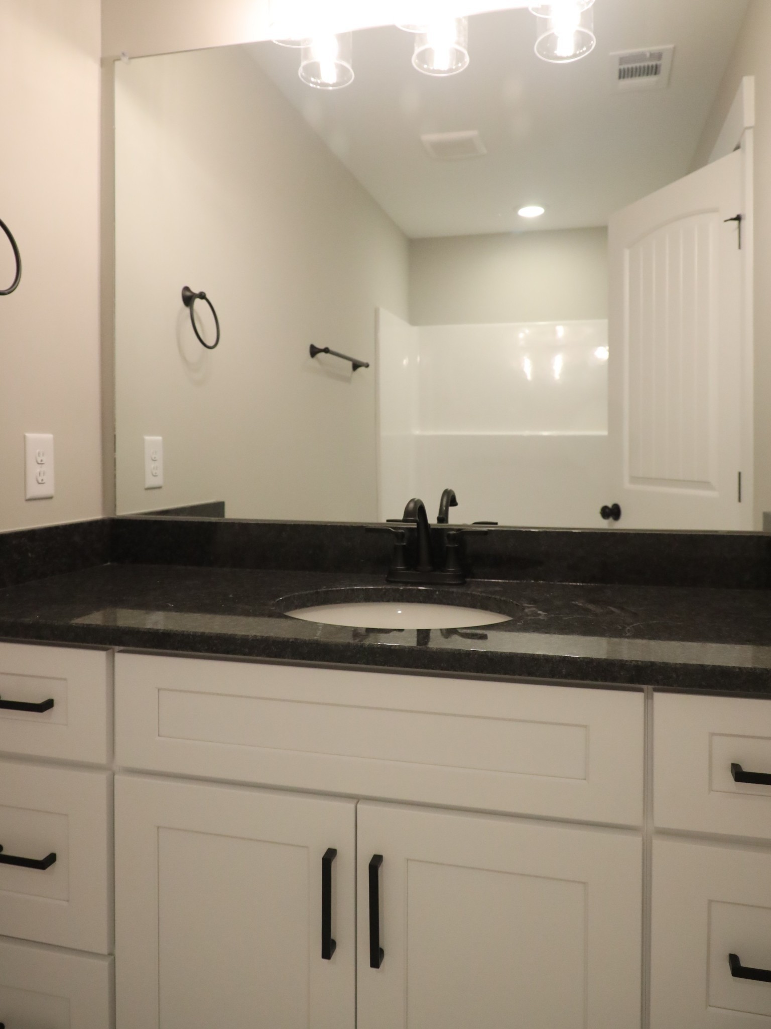 5558 Borthick Road Springfield, TN 37172 - Photo 39 of 53 a close view of sink with granite countertop white cabinets and a granite counter top