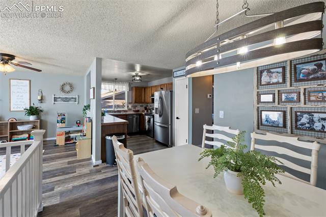 1830 Doherty Road Colorado Springs, CO 80916 - Photo 7 of 34 Dining space with dark hardwood / wood-style floors, ceiling fan, and a textured ceiling