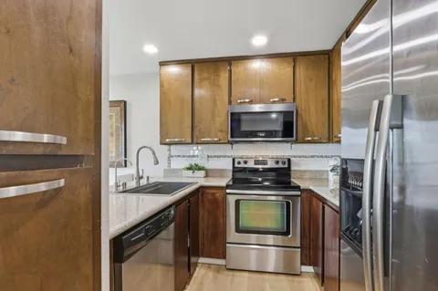 a kitchen with a sink stove and refrigerator