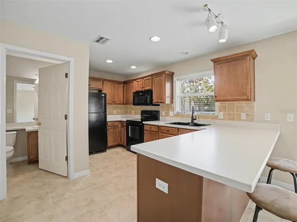 a kitchen with stainless steel appliances a refrigerator sink and microwave