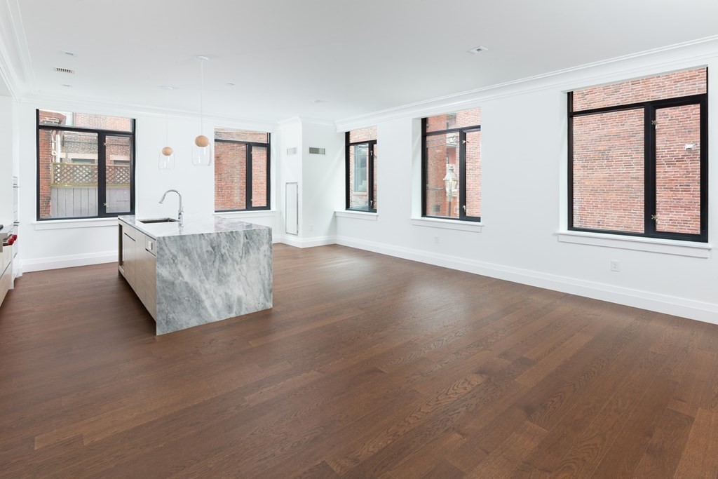 45 Temple Street, Unit 102 Boston, MA 02114 - Photo 3 of 15 a view of an empty room with window and cabinet