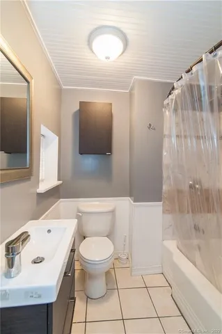 a view of small space with wooden floor and a window