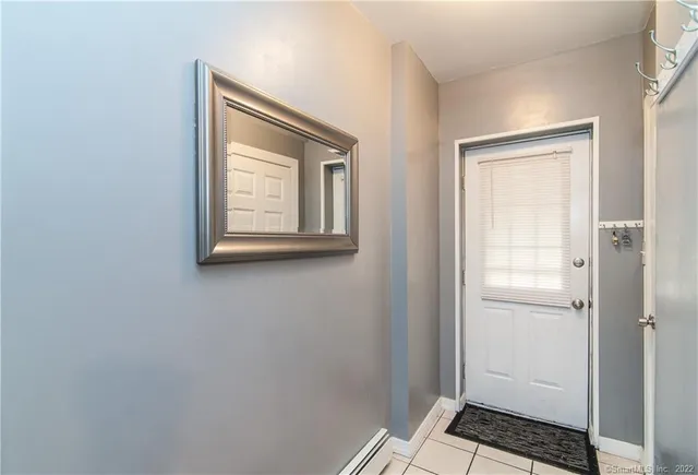 a backyard of a house with plants and barbeque oven