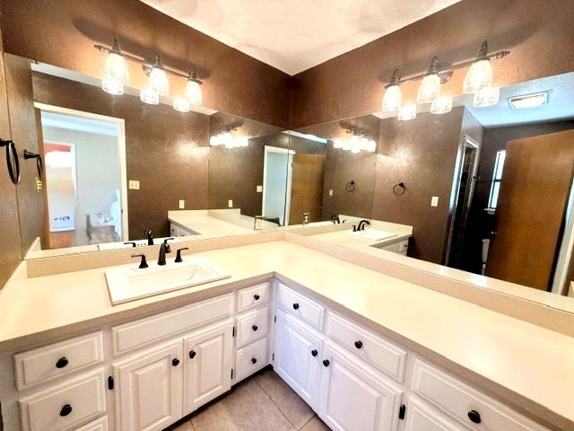707 Rimrock Road Kerrville, TX 78028 - Photo 31 of 55 a bathroom with a double vanity sink and a mirror
