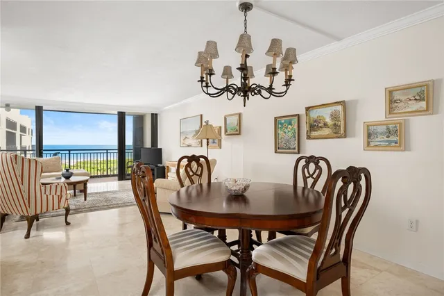a view of a dining room with furniture wooden floor and chandelier
