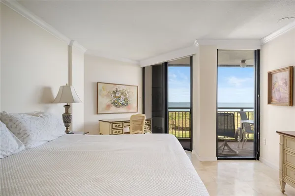 a bedroom with a large bed and a large window