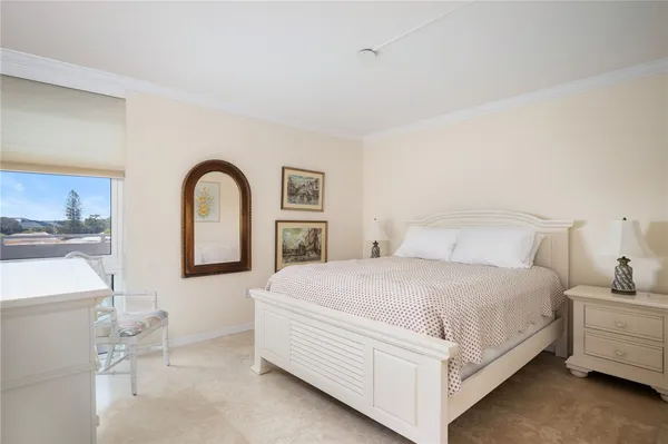 a bedroom with bed a lamp and dresser