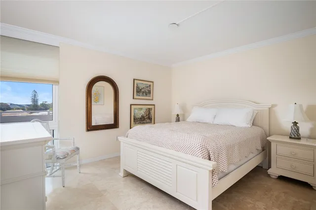 a bedroom with bed a lamp and dresser