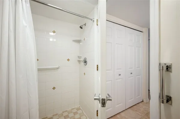 a bathroom with a glass shower door
