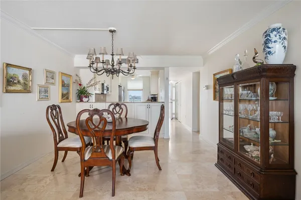 a view of a dining room with furniture wooden floor and chandelier