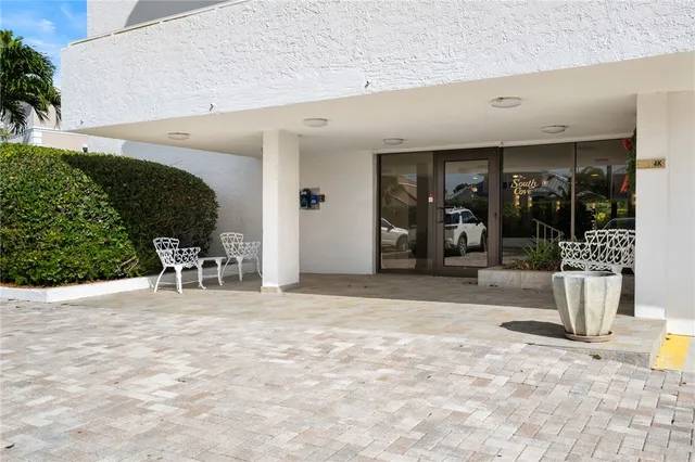 a view of a patio with table and chairs and potted plants