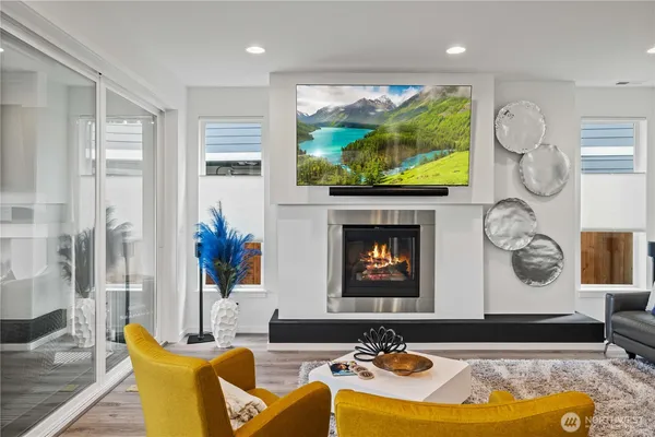 a living room with furniture flat screen tv and a fireplace