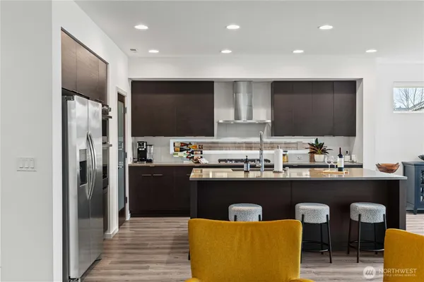 a kitchen with stainless steel appliances granite countertop a sink and a refrigerator