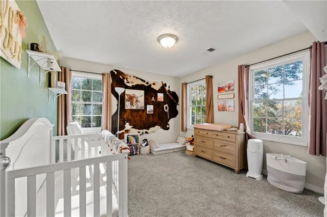 a bedroom with furniture and a large window